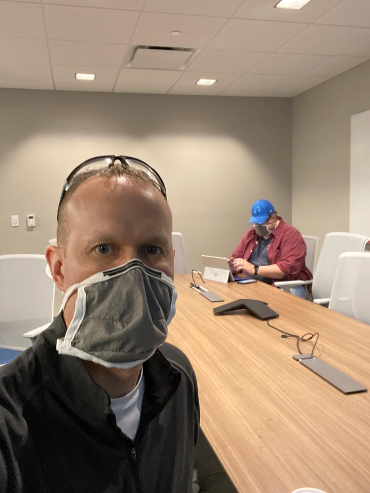 Hod practicing social distancing in a Zeeland conference room